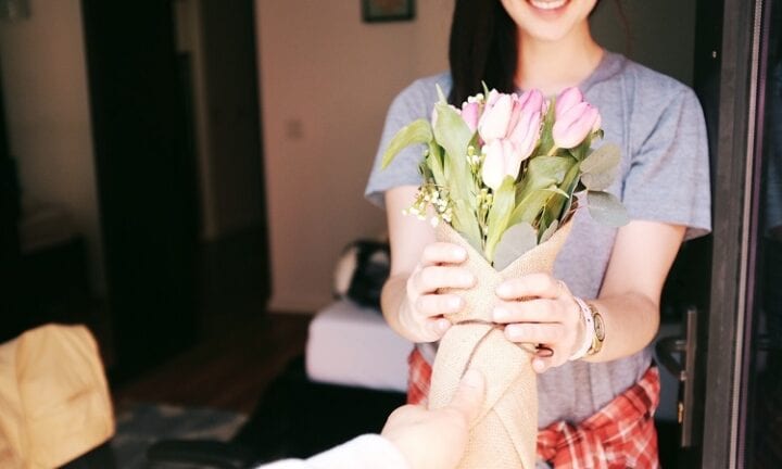 happy girl receiving flowers