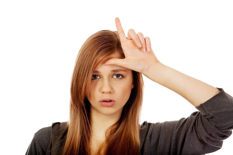 Woman giving a loser sign