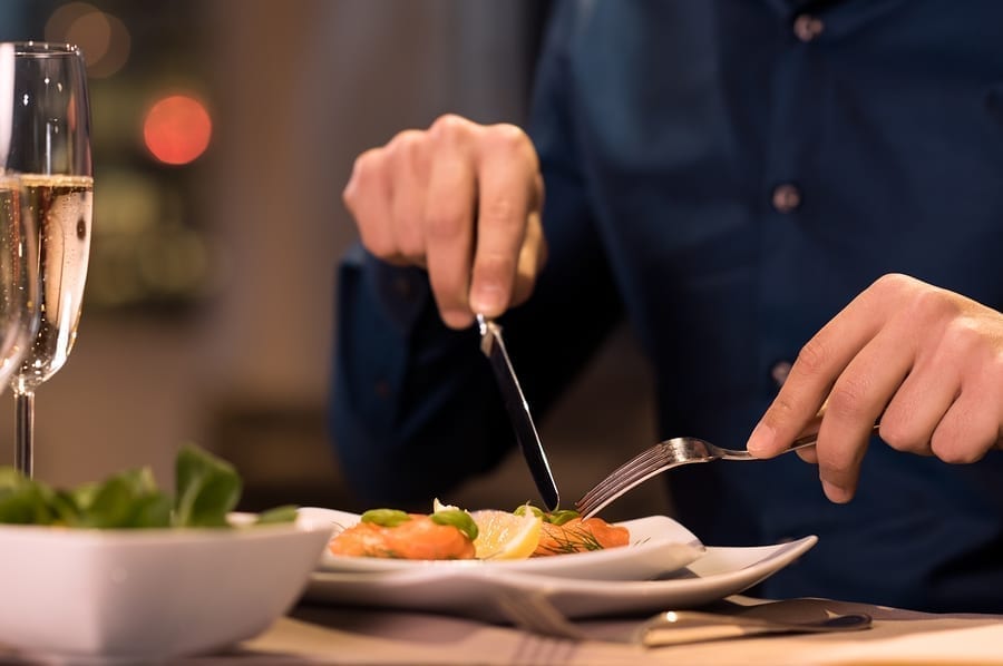 Man eating with knife and fork